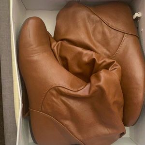 I’m selling brown faux leather boots.